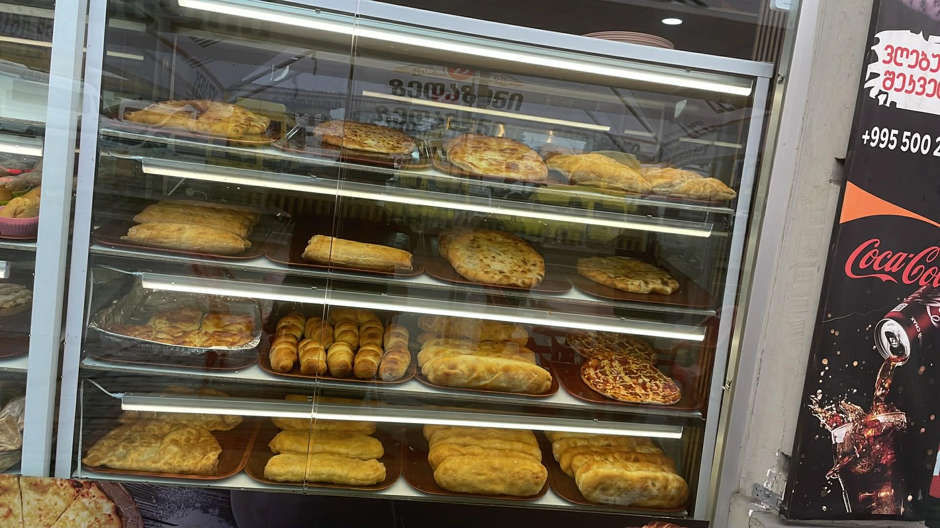 SHAUROOM bakery case with khachapuri, chebureki and pizza