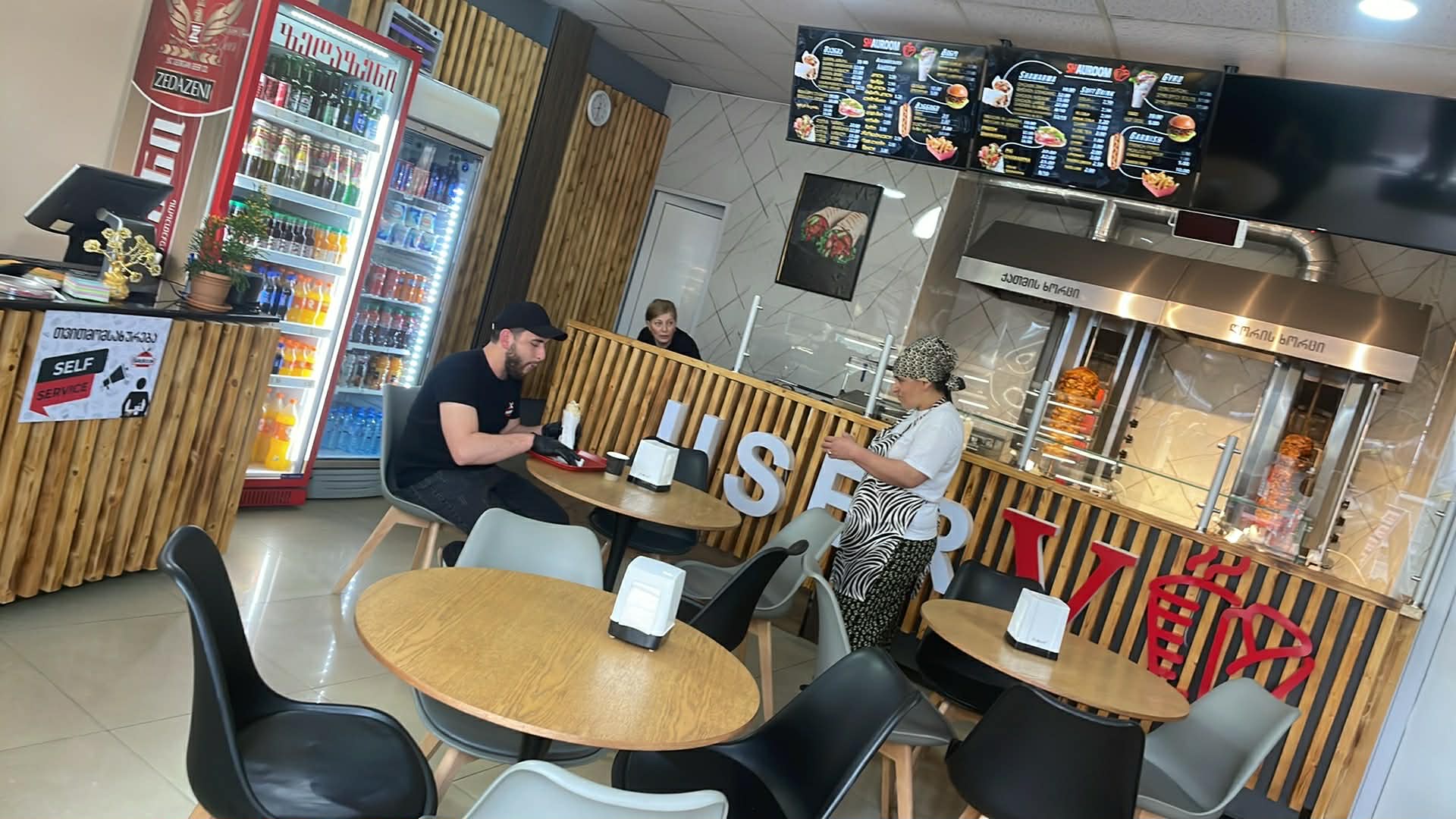 SHAUROOM dining room with shawarma spit in the background